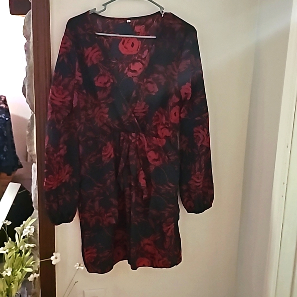 Navy blue long sleeve midi stress with red floral design.